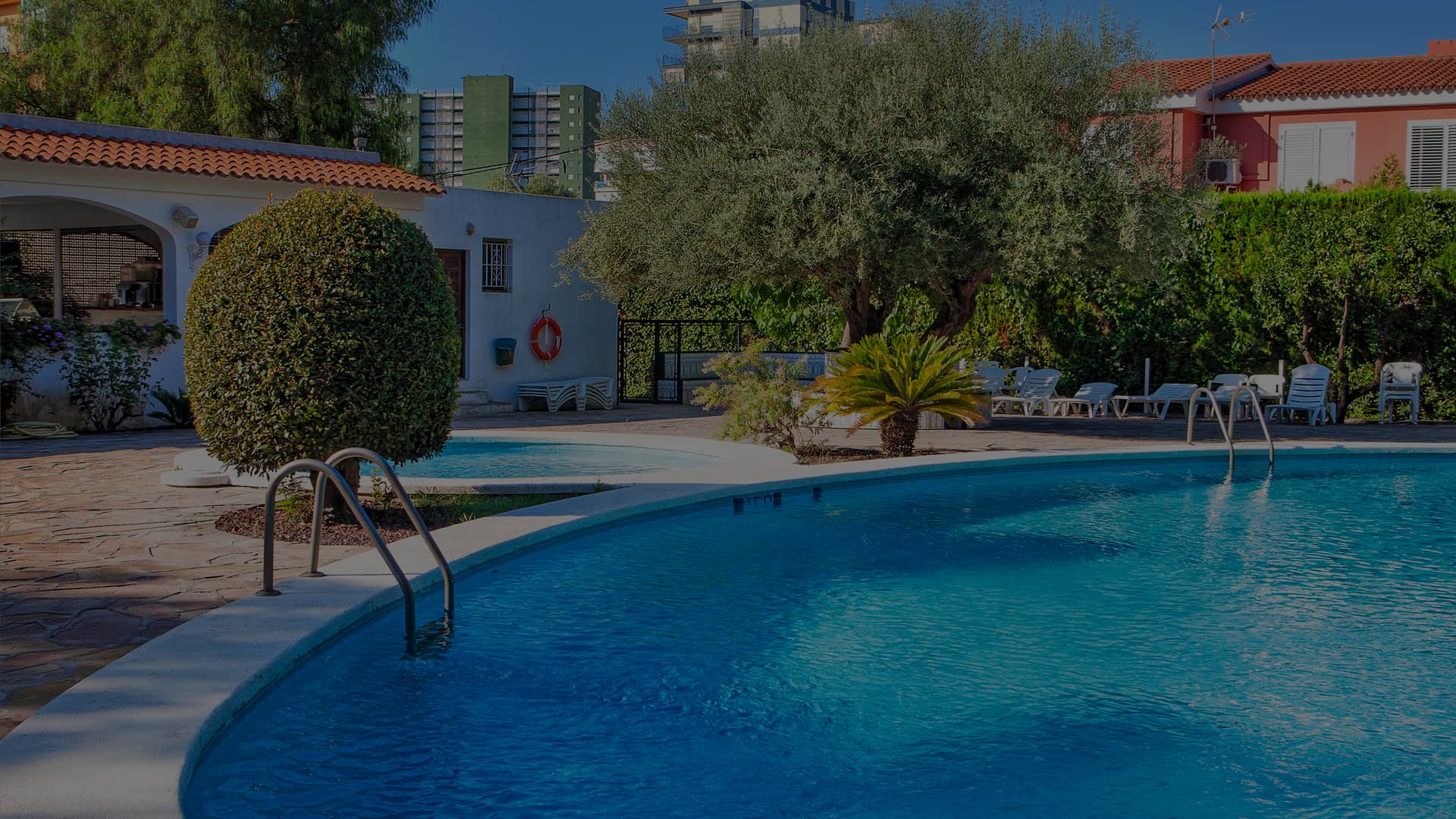 Pool area at the Hotel Vista Alegre, surrounded by plastic sun loungers.