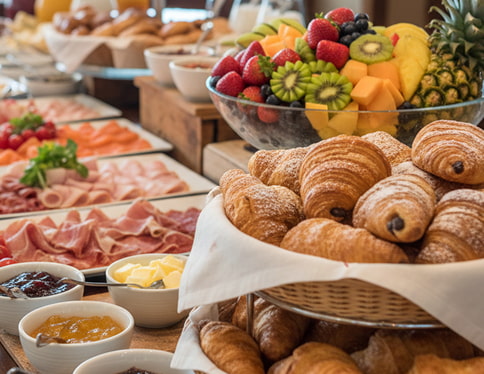 Buffet with fruit, cold meats and pastries